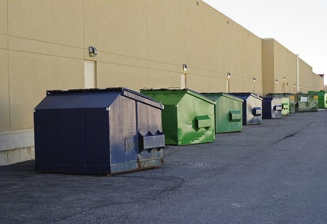 construction workers toss wood scraps into a dumpster in Highwood IL